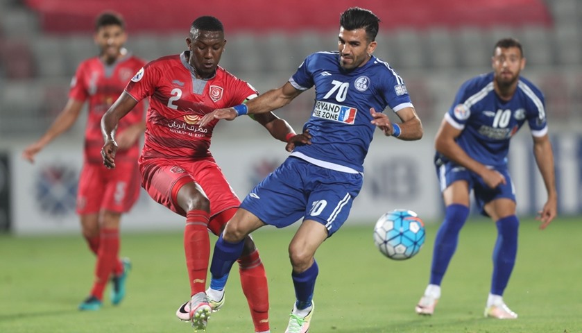 Lekhwiya\'s Mohamed Musa vies for the ball against Mehdi Momeni Larimi