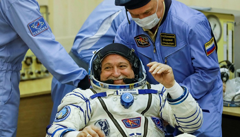 The International Space Station (ISS) crew member Fyodor Yurchikhin of Russia is assisted during his