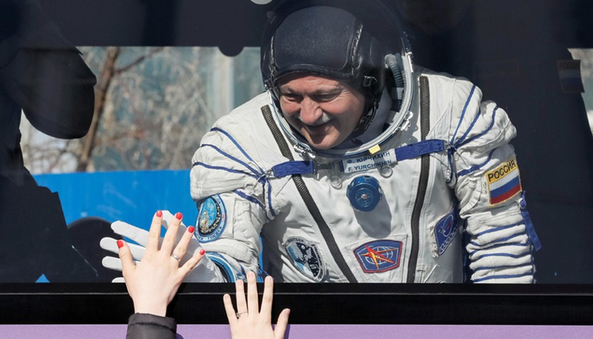 The International Space Station (ISS) crew member Fyodor Yurchikhin of Russia waves to his family