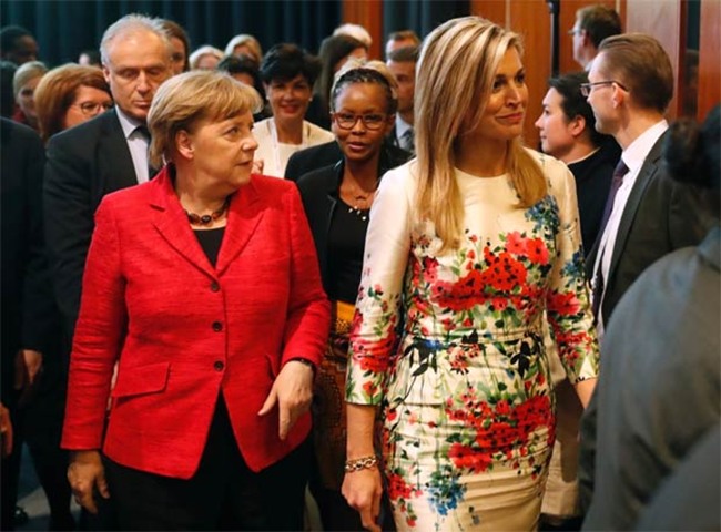 German Chancellor Angela Merkel and Queen Maxima leave after a panel discussion