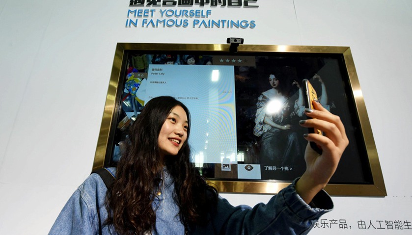 a woman trying a face recognition product as she visits the China International Cartoon and Animatio