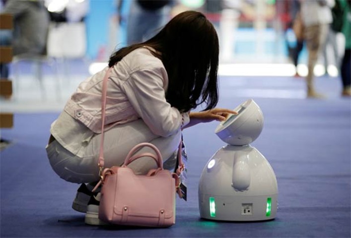 A staff member sets up a ROBOTLEO robot at the internet conference in Beijing