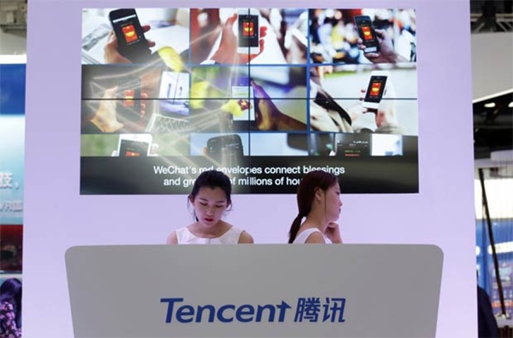 Information about Tencent\'s WeChat application is on display on a screen at its booth at GMIC