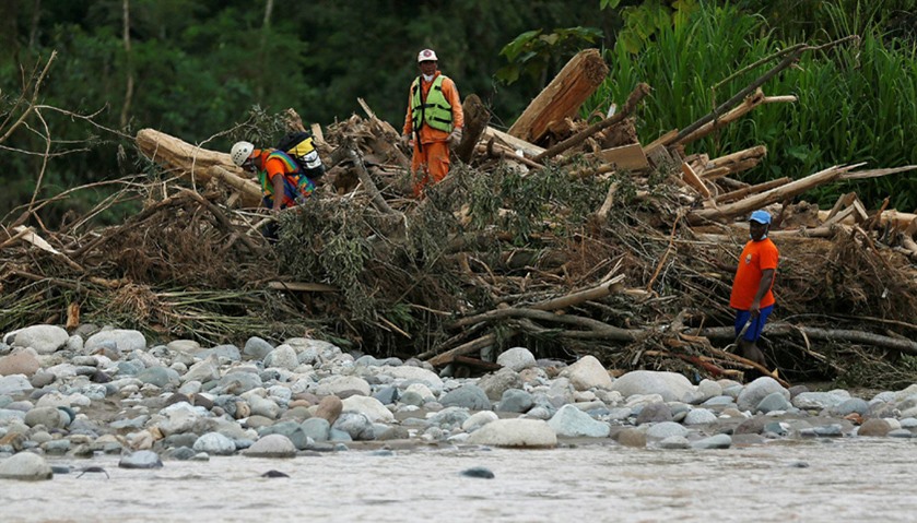 Rescuers look for bodies in the river after flooding and mudslides caused by heavy rains in Mocoa