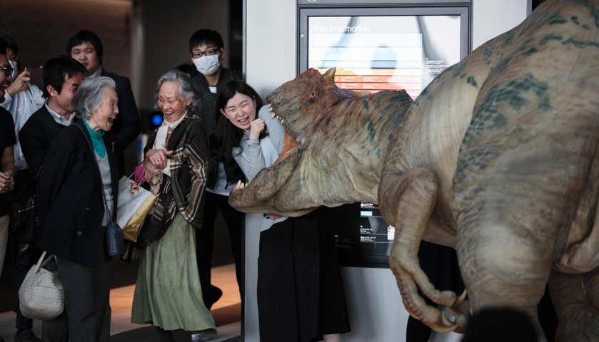 People react as dino-tronics robot performs at the Sky Lobby of Hikarie building