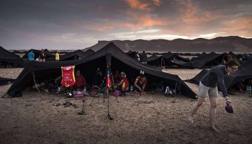 Competitors sit under tents at a bivouac after Stage 2 of the 33rd edition of the Marathon des Sable