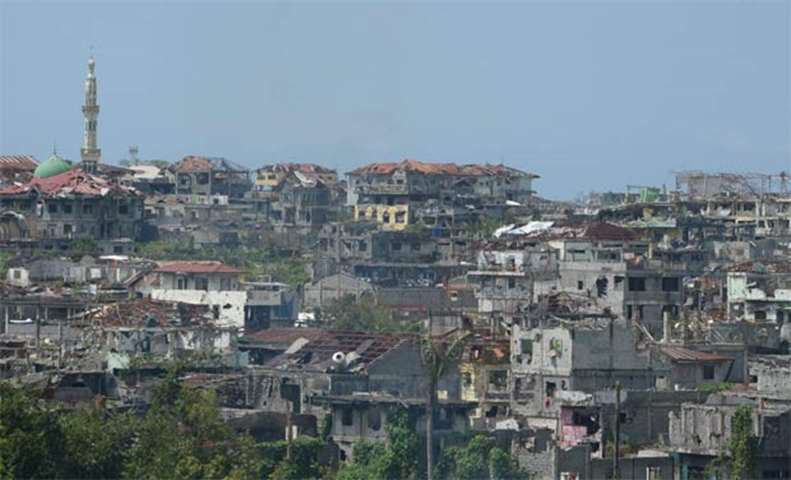 Destroyed buildings are seen in Marawi, while thousands of residents visited their houses