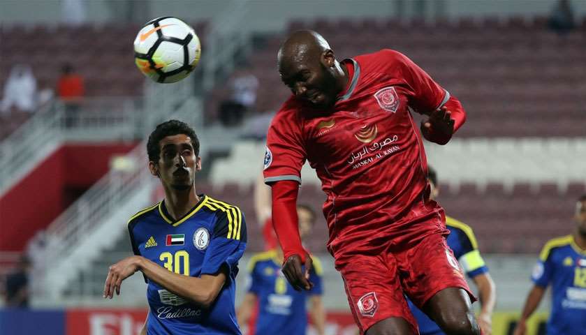 Duhail\'s defender Dame Traore (R) vies for the ball with Al-Wahda\'s forward Tareq Al-Antali