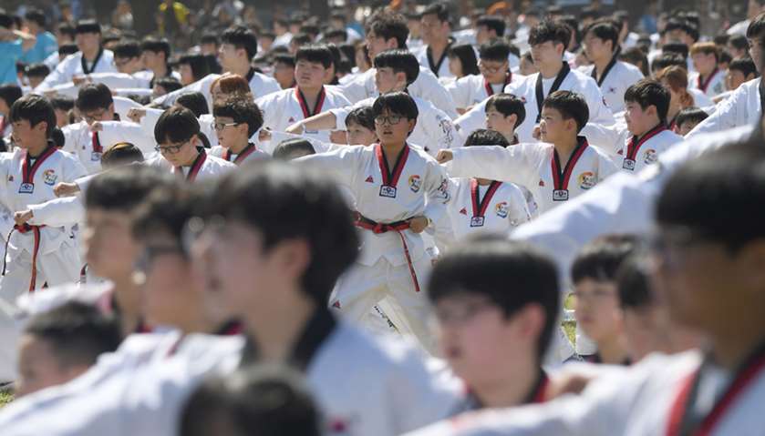 Taekwondo practitioners perform in a demonstration event outside South Korea\'s National Assembly bui