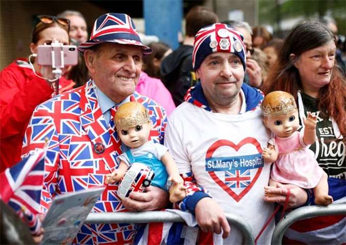 Supporters of the royal family hold dolls as they stand outside the Lindo Wing of St Mary\'s Hospital