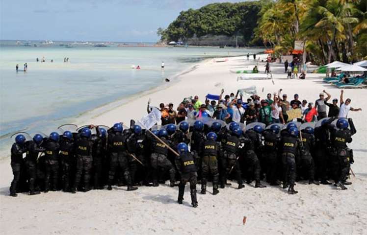 Policemen take part in a drill in preparation for the temporary closure of the holiday island