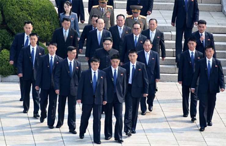 North Korean leader Kim Jong Un walks with his delegation on Friday