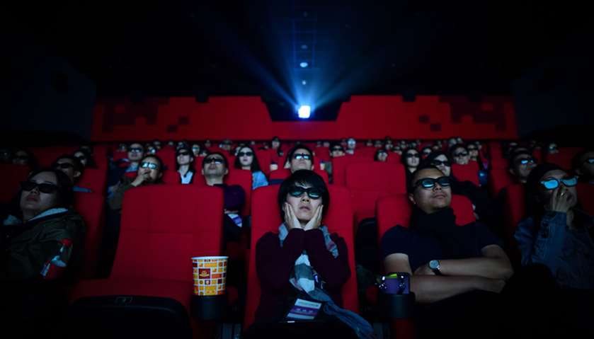 People watching a movie at a cinema in Wanda Group\'s Oriental Movie Metropolis in Qingdao, China