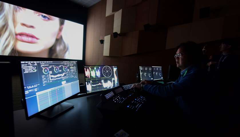 A producer performs colour correction at a film post-production studio at Wanda Film industrial park