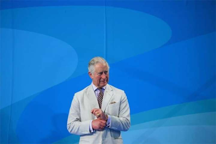 Prince Charles waits before the medal ceremony for the swimming women’s 200m freestyle final