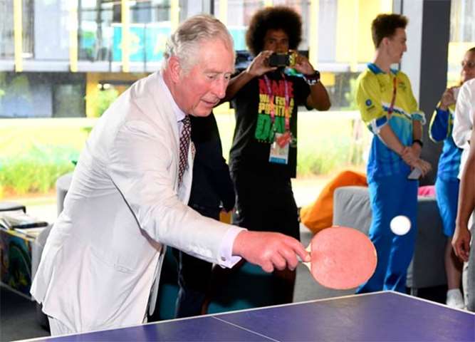 Prince Charles plays table tennis during a visit to the Commonwealth Games athletes\' village