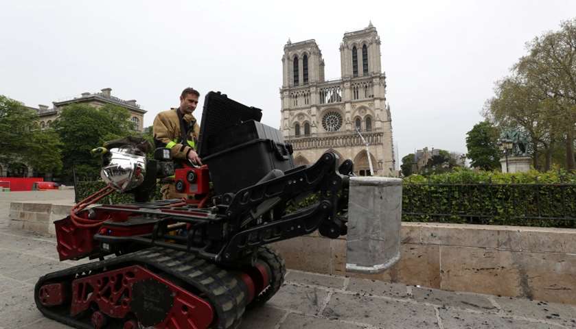 A firefighter works at Notre-Dame Cathedral