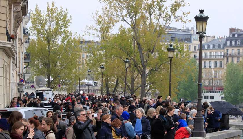 People look at Notre-Dame Cathedral