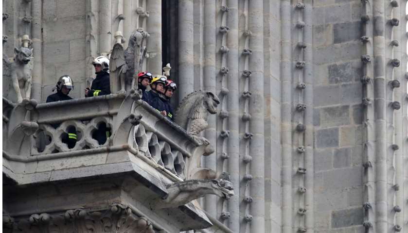 Firefighters work at Notre-Dame Cathedral