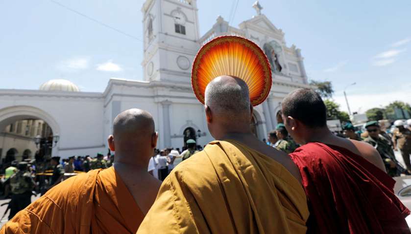 Buddhist monks stand in front of the St. Anthony\'s Shrine, Kochchikade church after an explosion in 