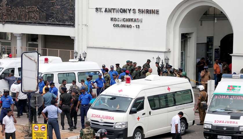 An ambulance is seen outside the church premises with gathered security personnel following a blast