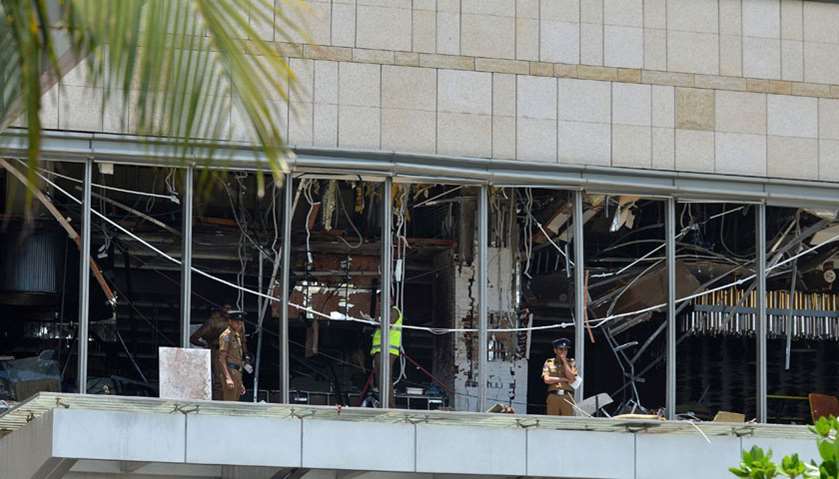 Sri Lankan police stand at the site of an explosion in a restaurant area of the luxury Shangri-La Ho