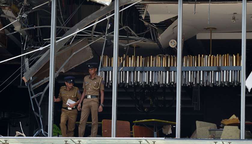 Sri Lankan police stand at the site of an explosion in a restaurant area of the luxury Shangri-La Ho