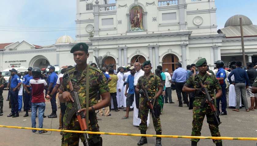 Sri Lankan security personnel keep watch outside the church premises following a blast at the St. An