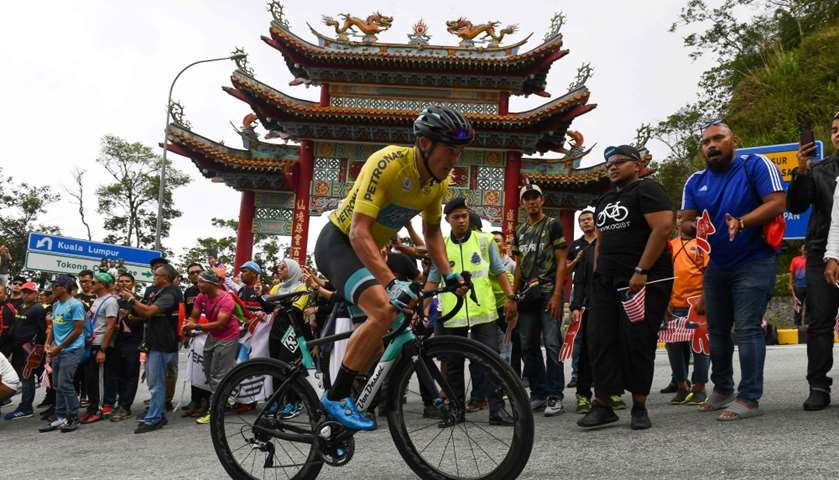 Floyd\'s Pro Cycling\'s rider Travis Mccabe of US rides past Chin Swee Caves Chinese temple