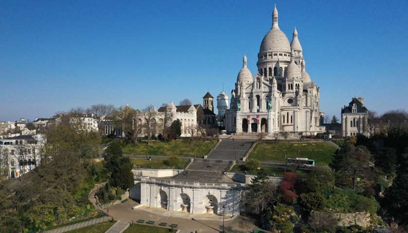 An aerial view shows the deserted Butte Montmartre and the Sacre-Coeur Basilica in Paris