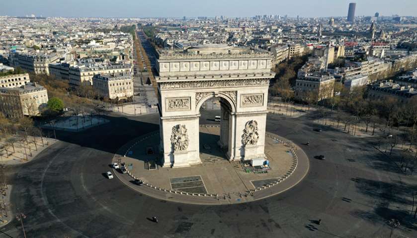 An aerial view shows the deserted Place de l\'Etoile and the Arc de Triomphe in Paris