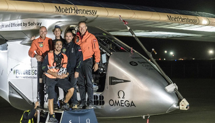 Pilots pose with crew members in front of Solar Impulse 2 (Si2),