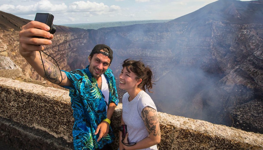Tourists make a selfie at the crater of the Masaya Volcano in Masaya