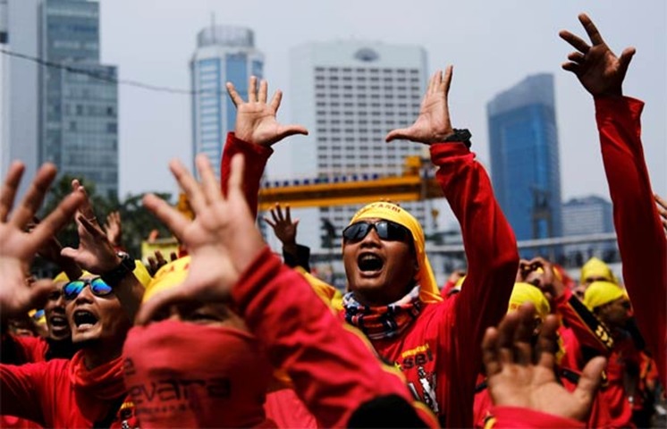 Indonesian workers shout slogans during a May Day rally in Jakarta