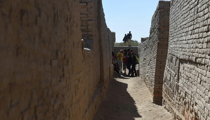 Visitors walk through the UNESCO World Heritage archeological site of Mohenjo Daro