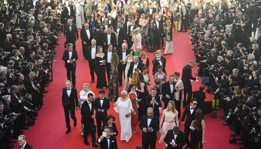 People arrive during the opening ceremony of the 70th edition of the Cannes Film Festival