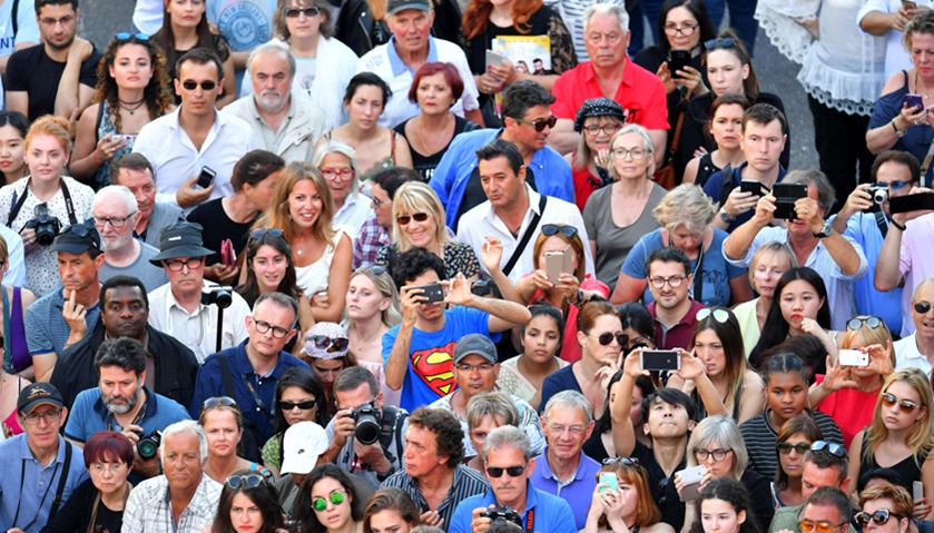 Fans look at guests arriving for the opening ceremony of the 70th edition of the Cannes Film Festiva