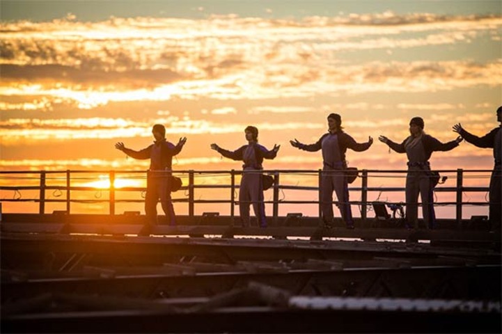 The sun rises over the Sydney Harbour Bridge, as the martial arts class is held
