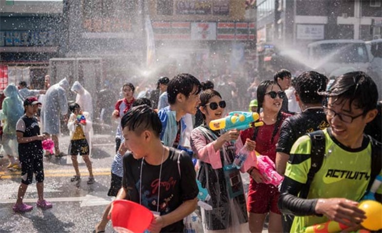 Participants soak up the fun during a water fight organised to mark the opening of the festival