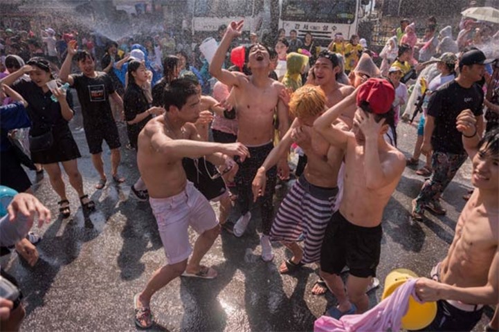 People dance during a water fight in Chuncheon