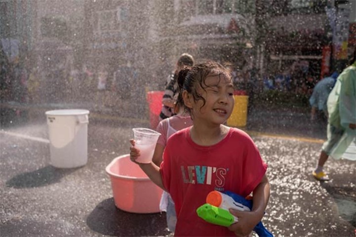 A girl takes part in a water fight organised to mark the opening of the week-long festival
