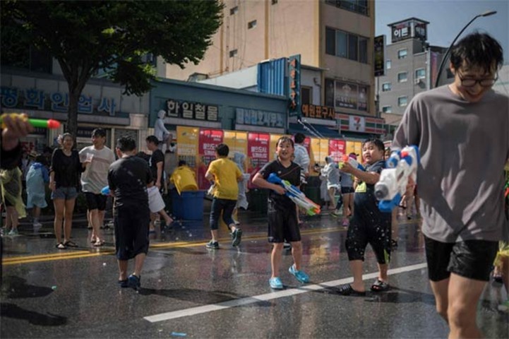 Roads are wet as people take part in a water fight in the South Korean city Chuncheon