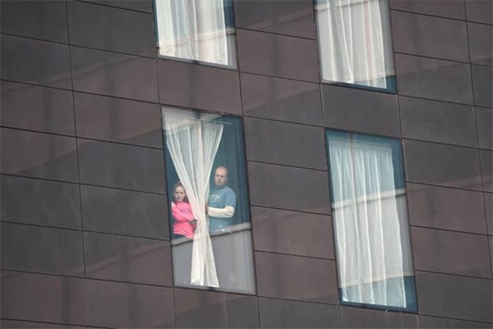 People affected by the deadly terror attack look out from a hotel window in Manchester