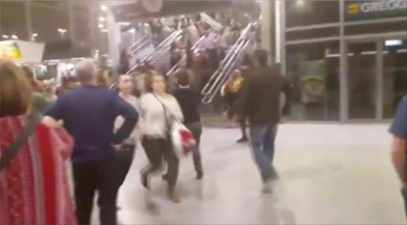 People running down stairs as they attempt to exit the Manchester Arena after a blast
