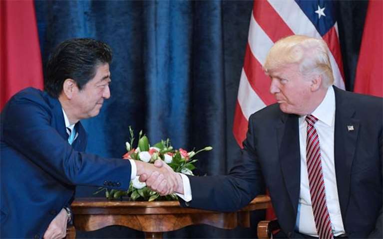 US President Donald Trump shakes hands with Japanese Prime Minister Shinzo Abe in Taormina, Sicily