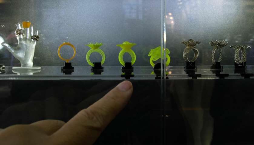 A visitor points at a plastic ring made by a 3D printer during the Computex Show in Taipei