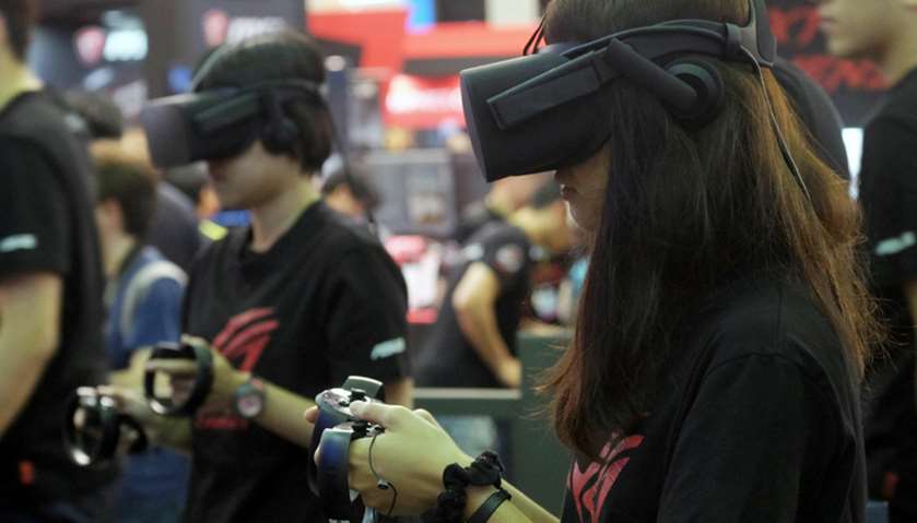 Visitors test virtual reality VR headsets during the Computex Show