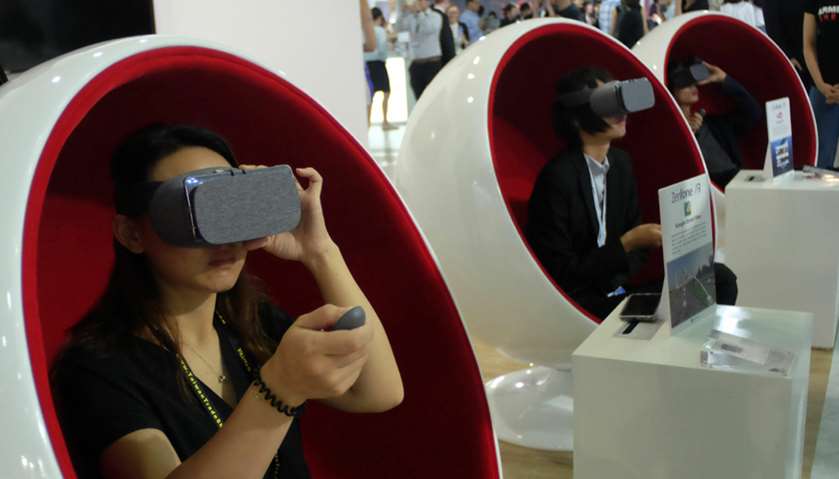 Visitors test virtual reality VR headsets made by Taiwan\'s Asus