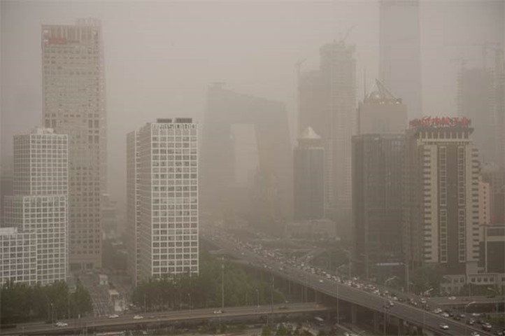 Parts of the central business district in Beijing are shrouded in a dust storm on Thursday