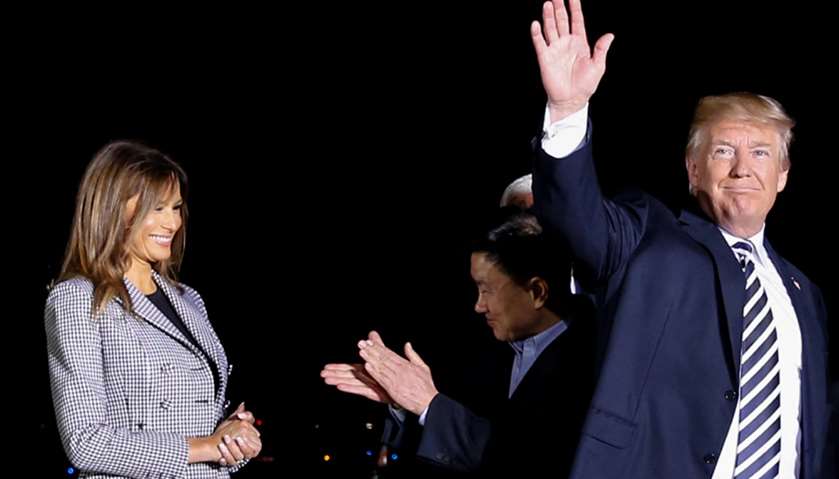 Trump waves as Tony Kim (2nd R) applauds first lady Melania Trump